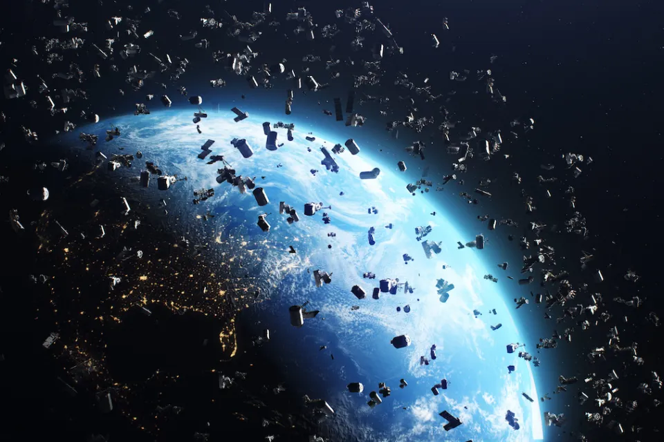 Rendering of many satellites in near-earth orbit with earth visible behind them.